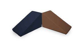 The image shows two triangular Mega Wedge Play Triangles from Foamnasium, crafted from durable foam playset material, placed together. One cushion is dark blue, and the other is brown. They are positioned in such a way that they form an inverted 'V' shape, touching at their smaller ends.