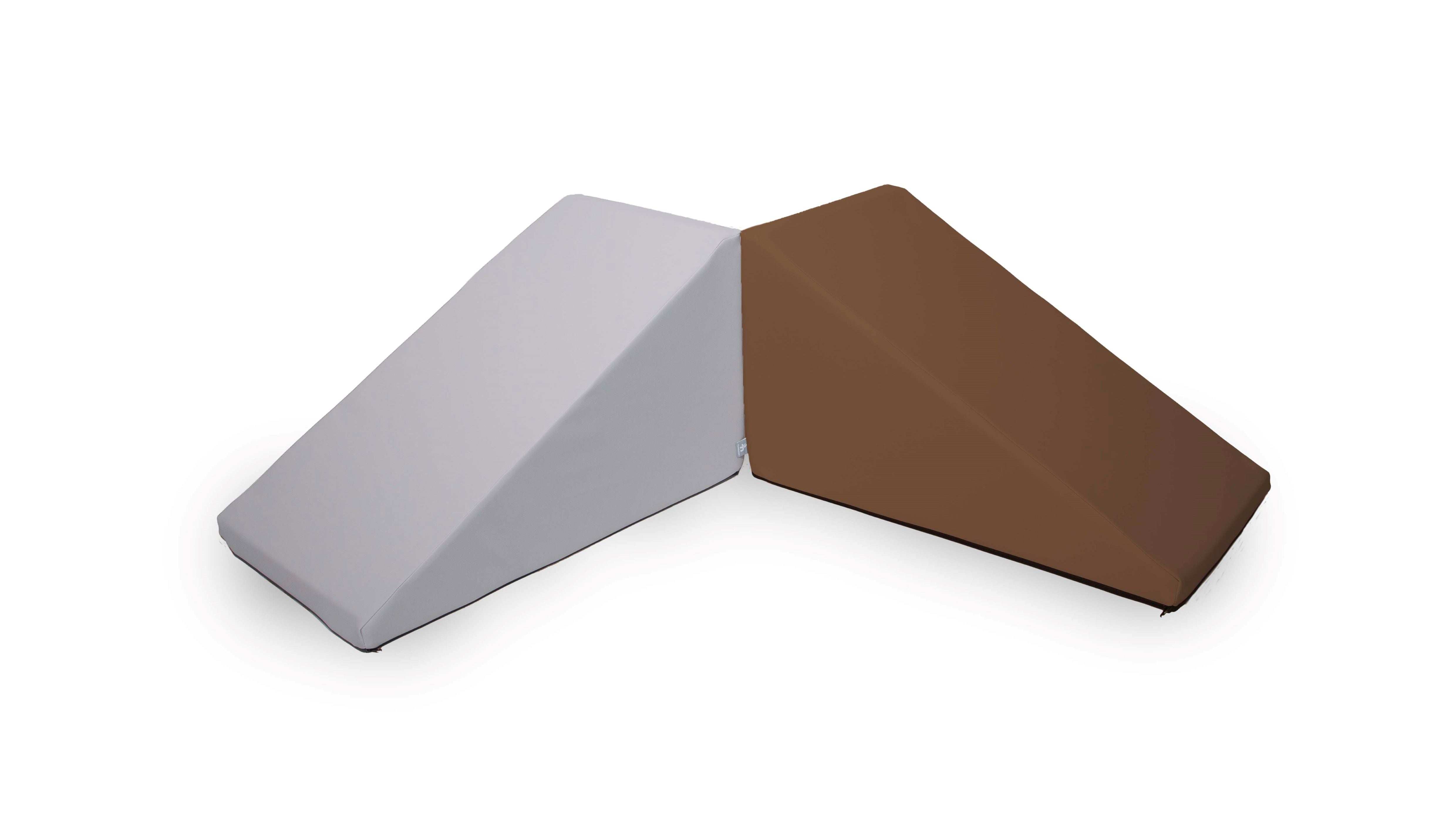 Two wedge-shaped cushions, called Mega Wedge Play Triangles by Foamnasium and CertiPUR-US certified, are positioned next to each other against a white background. One cushion is gray, and the other is brown. The cushions have triangular profiles and are designed for ergonomic support or lounging.