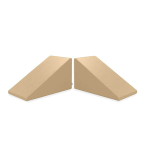 The Mega Wedge Play Triangles by Foamnasium consist of two beige foam wedges positioned side by side, creating a symmetrical arrangement. Each wedge has a rectangular base and a sloping top surface, forming a triangular prism shape. This durable foam playset is CertiPUR-US certified and designed for various activities, including exercise or support.