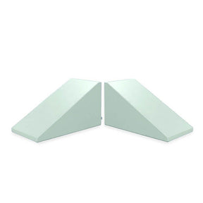 Two light blue foam wedge-shaped cushions, known as Mega Wedge Play Triangles by Foamnasium, are situated side by side against a white background. Each wedge is identical in size and shape, with one oriented to the left and the other to the right. These cushions are CertiPUR-US certified.