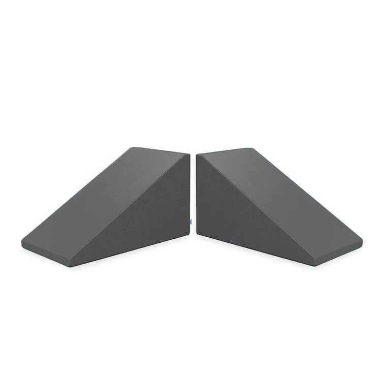 Image of two dark gray Mega Wedge Play Triangles from Foamnasium, positioned side by side. The wedges have a sloped design for sliding under doors to keep them open or secure, crafted from durable foam playset materials and GREENGUARD GOLD Certified for safety.